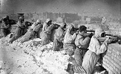 Soldiers behind a wall with guns